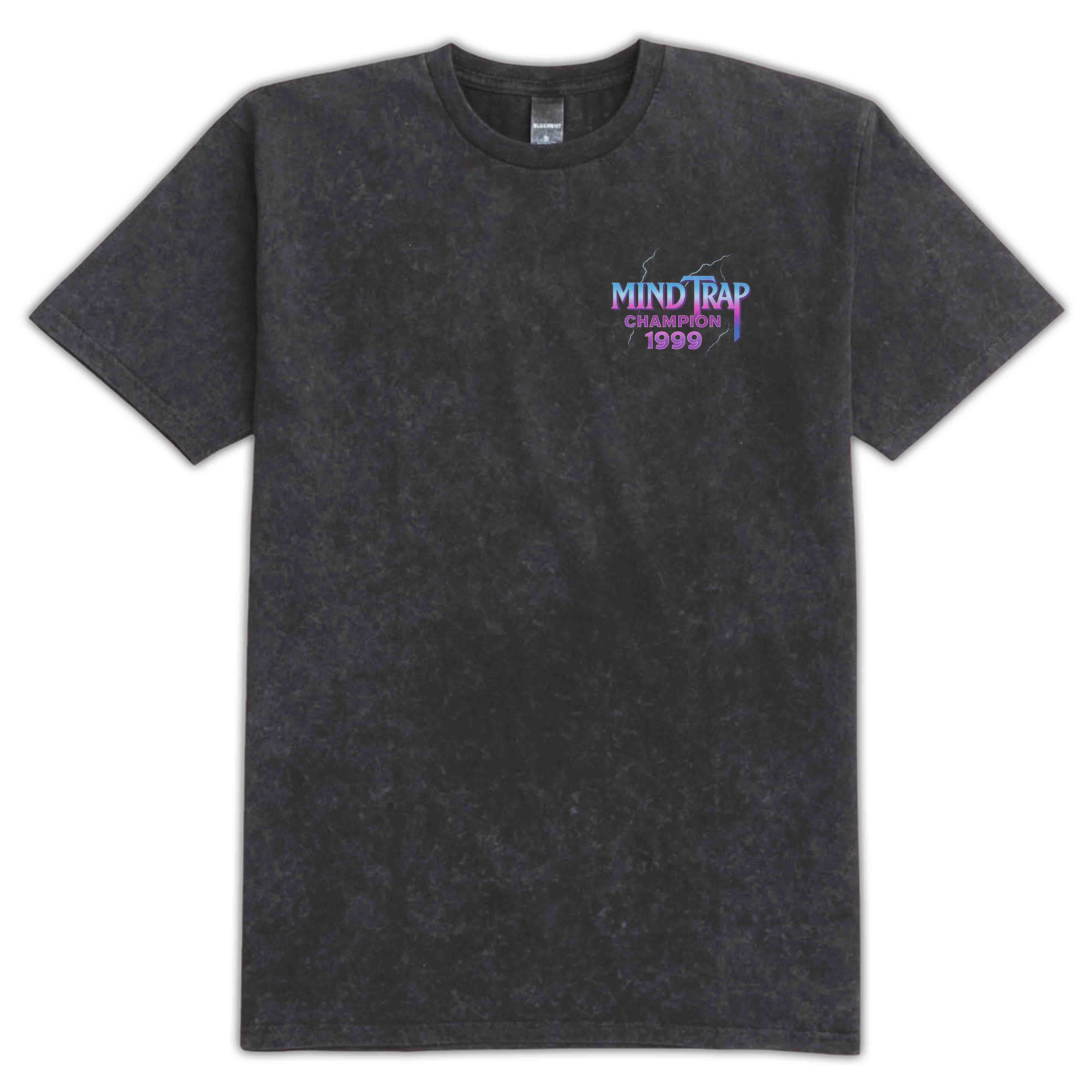 A dark gray acid-wash t-shirt with a small chest graphic reading 'MIND TRAP CHAMPION 1999' in blue and purple, displayed on a clean white background.